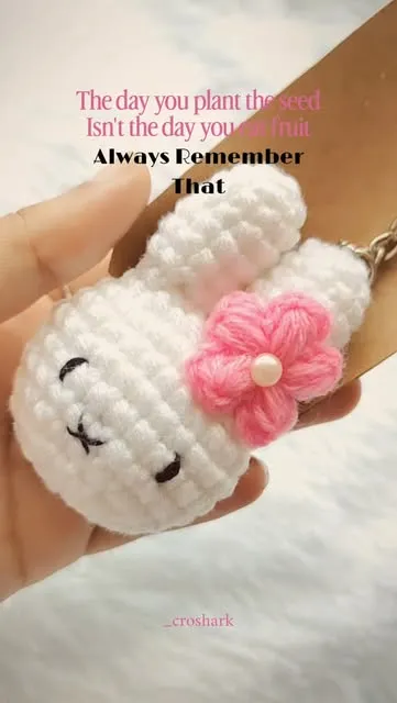 White crochet bunny keychain with a pink flower