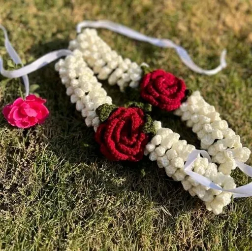 Crochet jasmine and rose hand gajra on grass